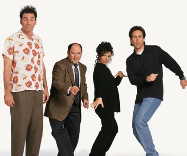 Four people striking playful poses against a white background, wearing casual 90s fashion.