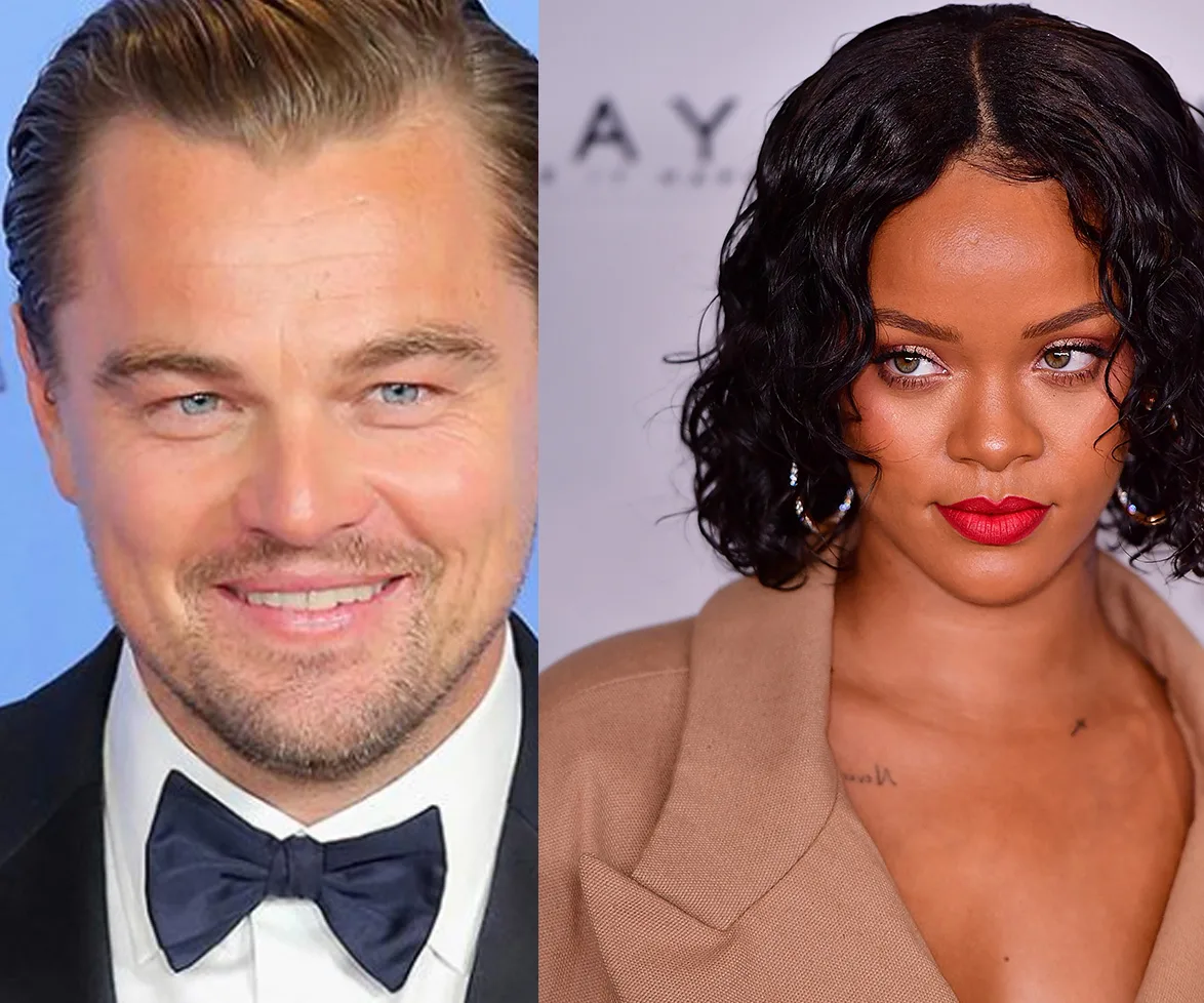 "Two individuals at an event, one in a tuxedo and the other in a stylish outfit with bold makeup and jewelry."