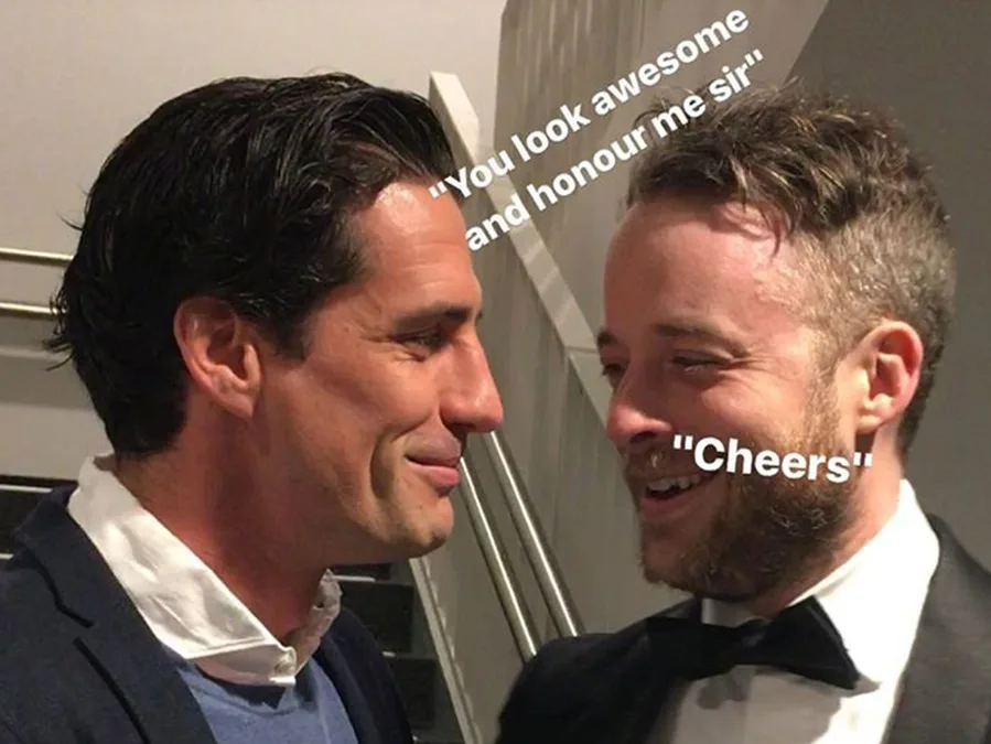 Two men smiling at each other, one in a suit and tie, with text overlay saying "You look awesome and honour me sir" and "Cheers".