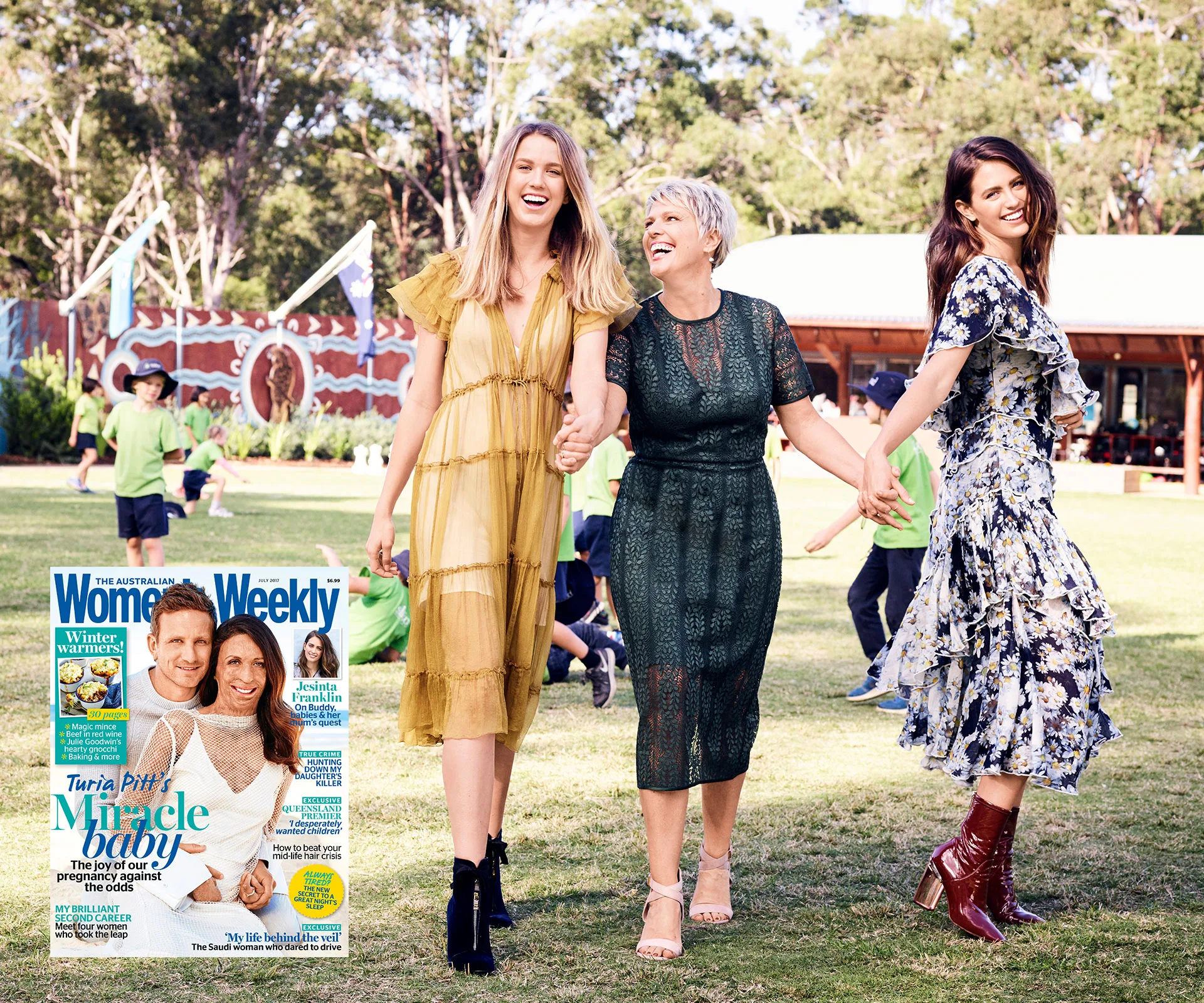 Three women holding hands and smiling in a grassy area, with children playing in the background. Magazine cover inset.