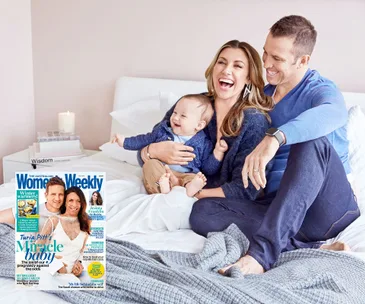 Family laughing on bed with a baby; Australian Women's Weekly magazine with Turia Pitt cover visible.
