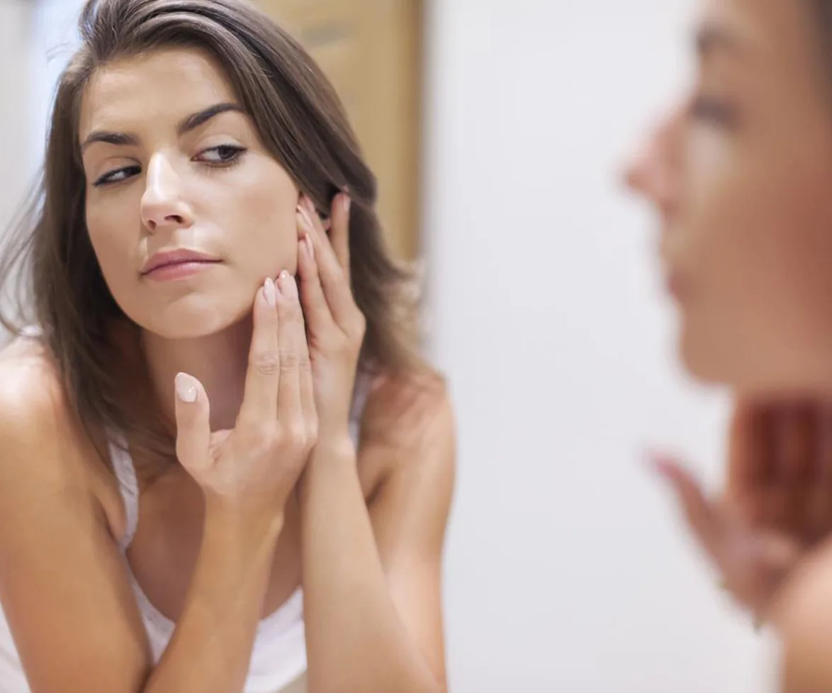 Woman popping pimples