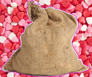 A burlap sack against a background of pink, red, and white heart-shaped candies.