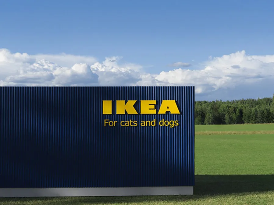 IKEA's pet furniture ad with a blue backdrop, text "For cats and dogs," against a scenic sky and greenery background.
