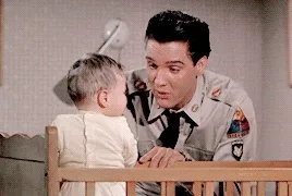 Elvis playing with a baby