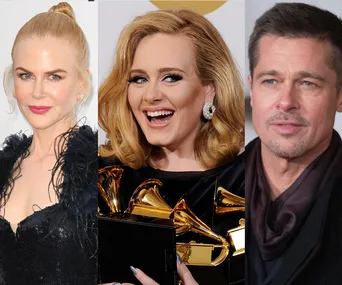 Three people posing at a red carpet event; includes individuals with an award.