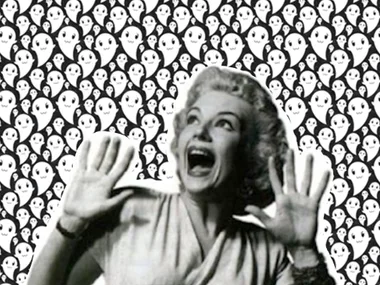 A woman screams with hands raised against a background of cartoon ghosts.