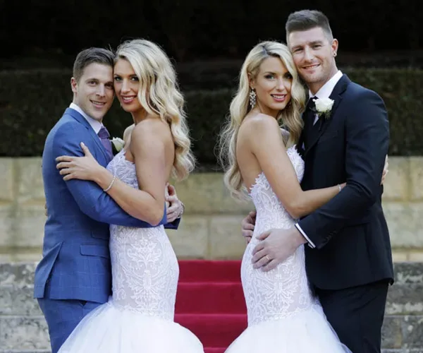 Couples pose in wedding attire on red carpet, smiling warmly.