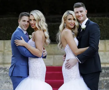 Couples pose in wedding attire on red carpet, smiling warmly.
