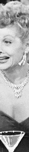 A black and white image of a smiling woman in an elegant gown pouring a drink, surrounded by martini glasses.