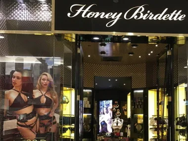 Storefront of Honey Birdette with lingerie advertisement featuring two models.