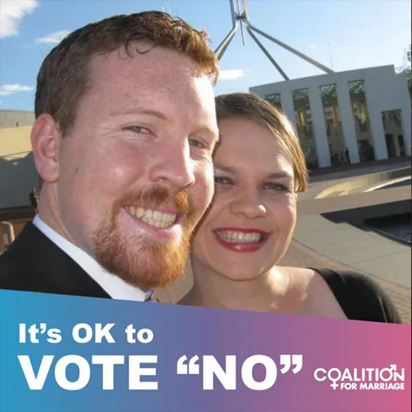 Couple smiling in front of a government building; text reads "It's OK to vote NO", by Coalition for Marriage.