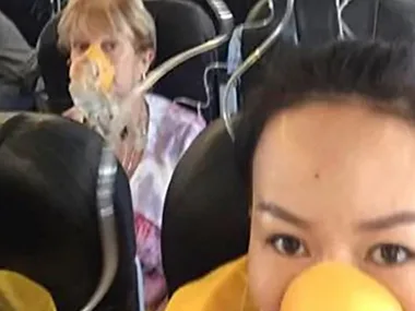 Passengers wearing oxygen masks during in-flight emergency on AirAsia flight from Perth to Bali.