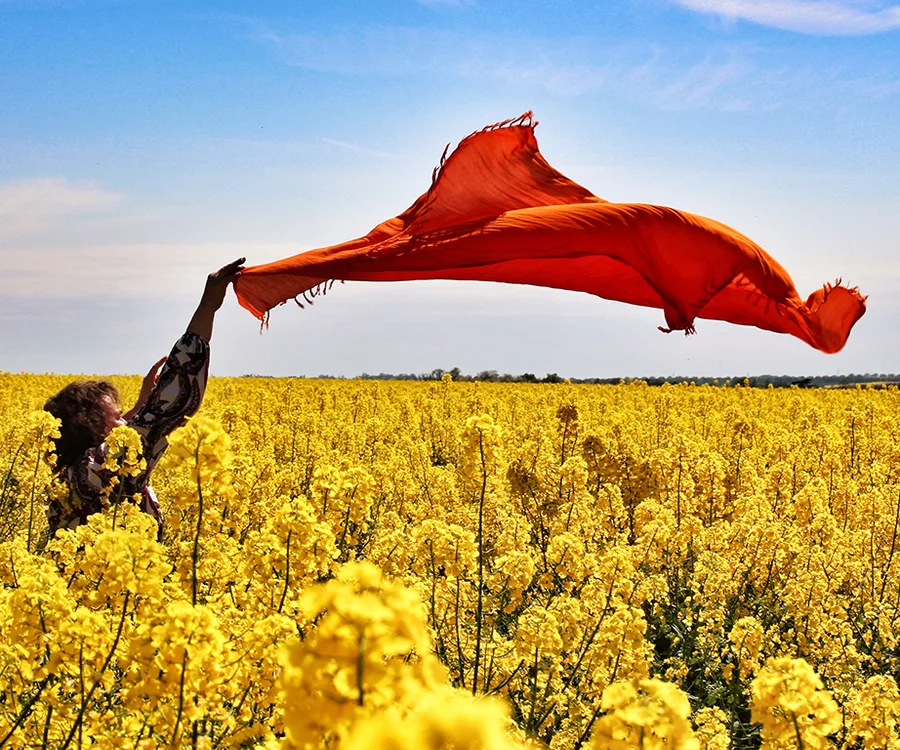 Woman feeling free in a grapeseed oil plantation