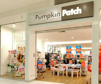 Front view of Pumpkin Patch store with clothing displays and sale signs.