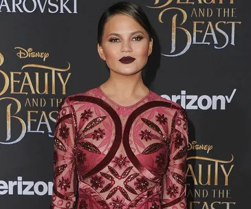 Model in a red patterned dress at "Beauty and the Beast" premiere.