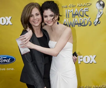 Two women embrace on the red carpet at the 41st NAACP Image Awards, smiling for the camera.