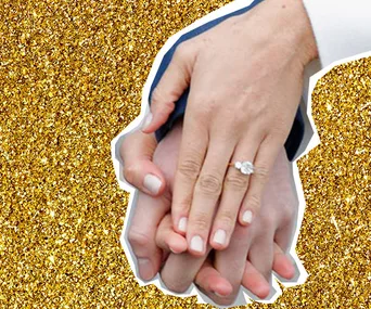 Hands with an oval engagement ring against a gold glitter background.