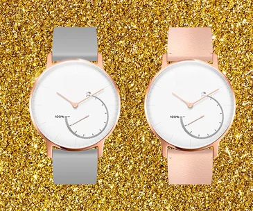 Two sleek smartwatches with gold accents, one with a gray strap and one with a pink strap, on a gold glitter background.