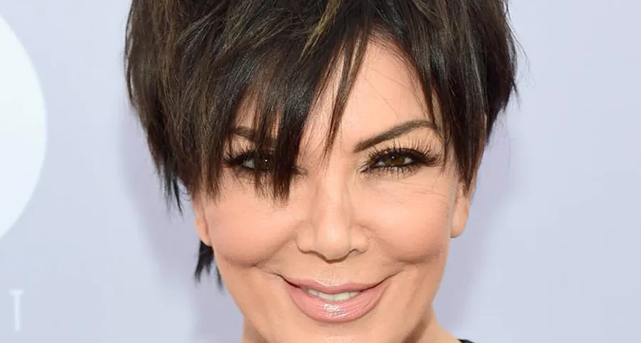 A woman with short dark hair smiling.