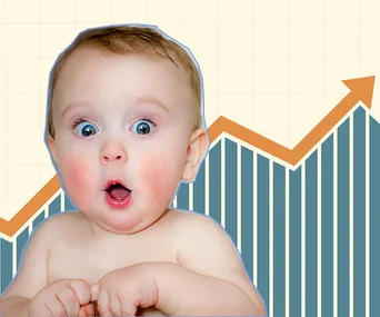 Surprised baby in front of a rising graph, suggesting popularity increase.