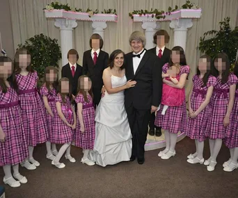 Couple in formal attire with children in pink dresses and suits, faces pixelated, in a ceremonial setting.