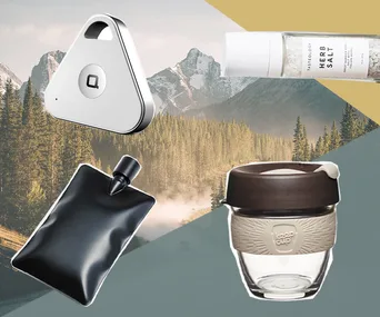 Gifts for men: a tracker, herb salt, black pouch, and KeepCup against a mountain background.