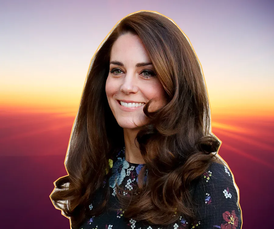Smiling woman with long, styled hair against a sunset background.