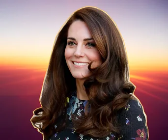 Smiling woman with long, styled hair against a sunset background.