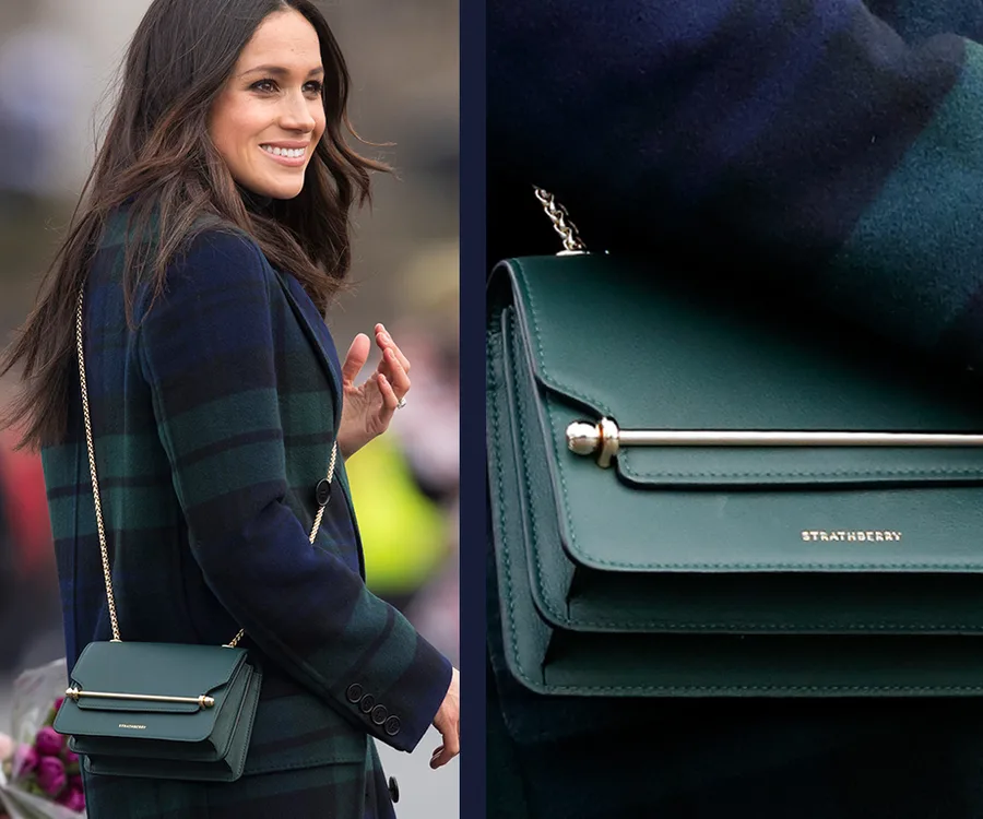 Meghan Markle wearing a checked coat, carrying a green Strathberry handbag with a gold chain.
