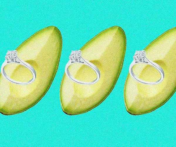 Three avocado slices with diamond rings against a turquoise background.