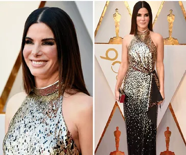 Sandra Bullock at an event in a shimmering halter-neck gown, posing and smiling on the red carpet.