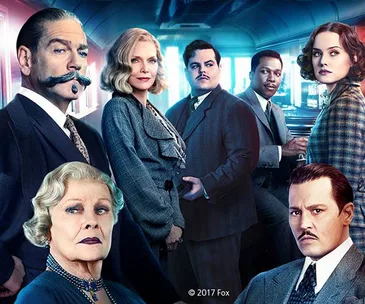 Cast of "Murder on the Orient Express" in vintage attire aboard a train. © 2017 Fox.