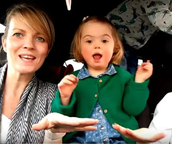 Woman and child with Down syndrome singing in a car for a Carpool Karaoke video.