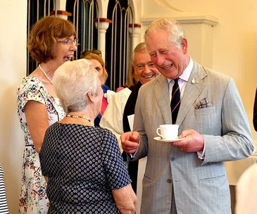 Prince Charles heads to Cairns for a packed day with tears, tea and bugles