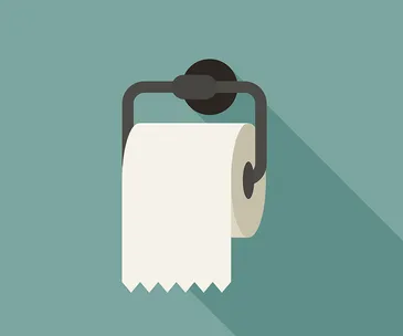 A roll of toilet paper hanging on a holder against a green background.