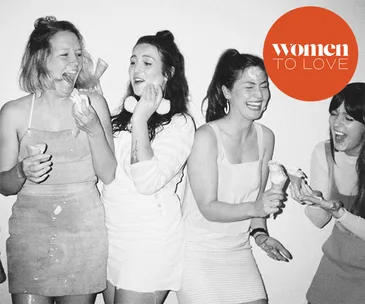 Group of women laughing and holding ice cream cones in a black and white photo with "women to love" logo.