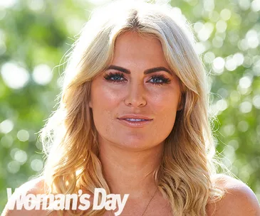 Blonde woman with long hair and bold makeup, outdoors, "Woman's Day" logo in corner.