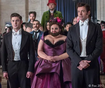 A scene from "The Greatest Showman" featuring three main characters dressed in formal attire.