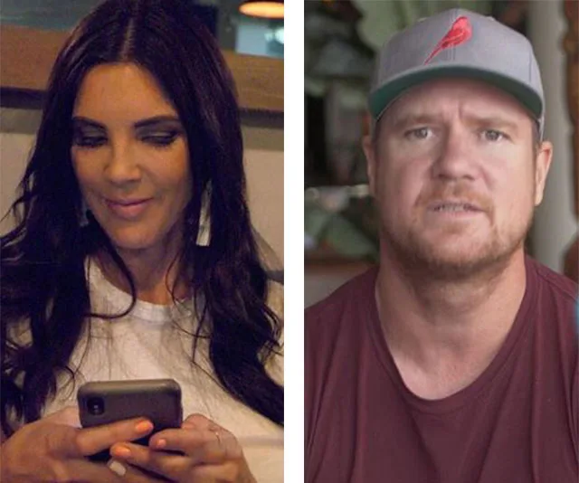 Woman looking at phone beside a man wearing a cap indoors.
