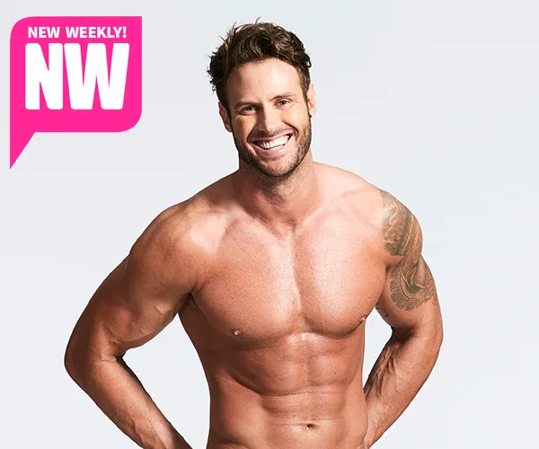 Man with short hair and tattoo poses shirtless, smiling; NW magazine logo in the corner.