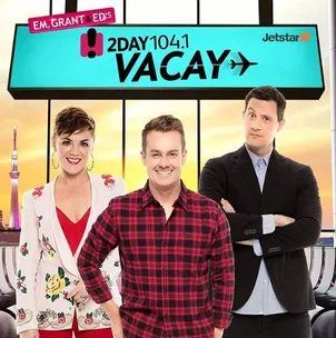Em, Grant, and Ed in front of a "2Day 104.1 Vacay" sign with the Tokyo skyline in the background.