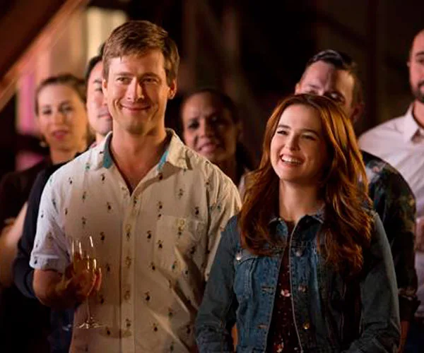 A scene from the 2018 Netflix film "Set It Up" featuring two smiling people at a gathering.