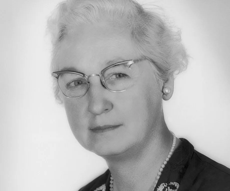 Portrait of Dr. Virginia Apgar, wearing glasses and a necklace, known for developing the Apgar Score for newborn health.