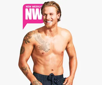 ```plaintext
Smiling shirtless man with tattoos, featured on New Weekly cover.
```