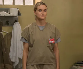 Piper Chapman in prison uniform in "Orange Is the New Black" Season 6 scene.