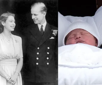 "Black and white photo of a young couple smiling alongside a sleeping newborn in white attire."