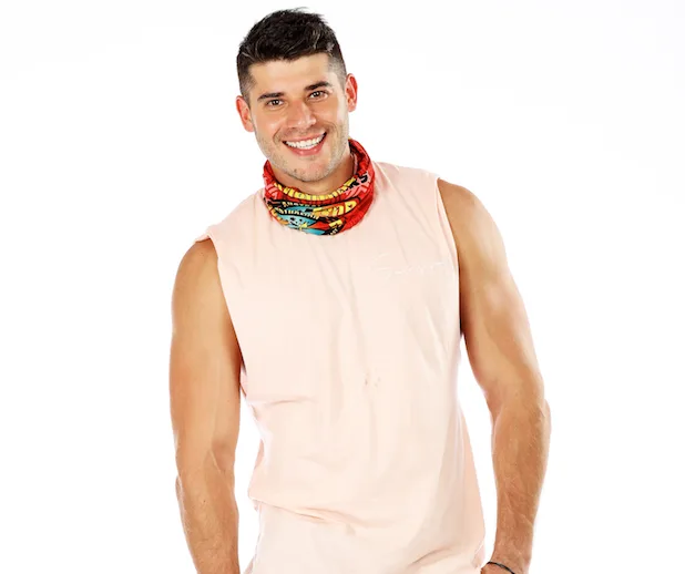 A smiling man in a sleeveless shirt and a colorful neck buff from Survivor Australia 2018.