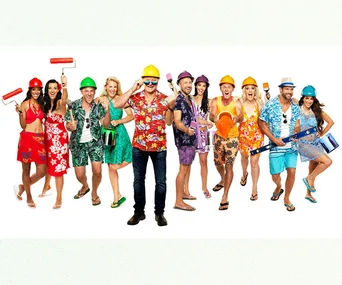 Contestants from The Block 2018 in colorful outfits and hard hats, holding painting tools, posing enthusiastically.
