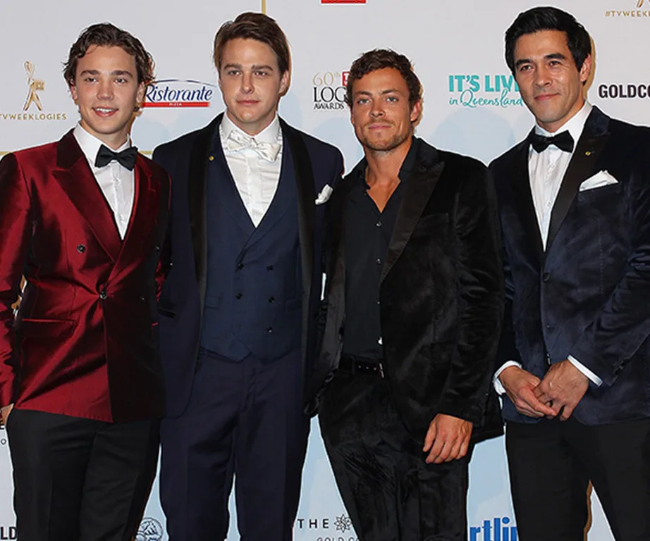 Four men in suits pose at the 2018 Logie Awards red carpet event.